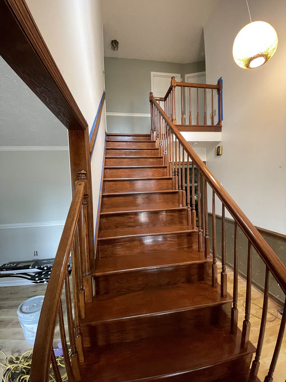 Refinished oak staircase treads, balusters, and curved handrail
